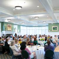 The audience listens to President Philomena V. Mantella speak